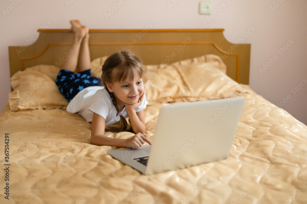 education, free time, technology and internet concept - little student girl with laptop pc at home education, free time, technology and internet concept - little student girl with laptop pc at home