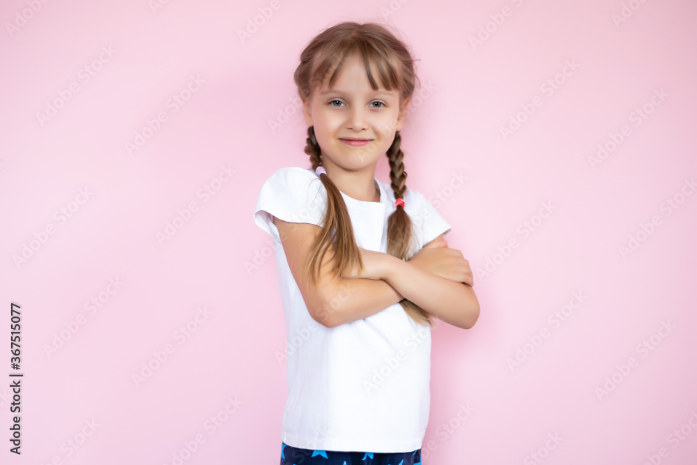 Beautiful little blonde girl with long hair in white T-shirt smiling on a pink background Beautiful little blonde girl with long hair in white T-shirt smiling on a pink background