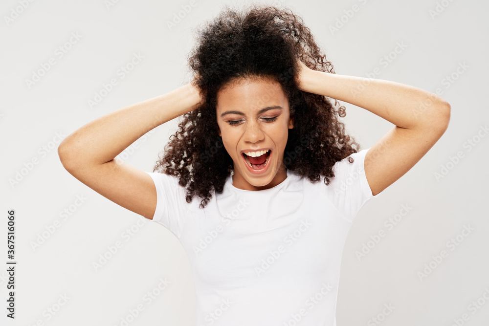 woman with dark curly hair holding her head emotions white t-shirt woman with dark curly hair holding her head emotions white t-shirt