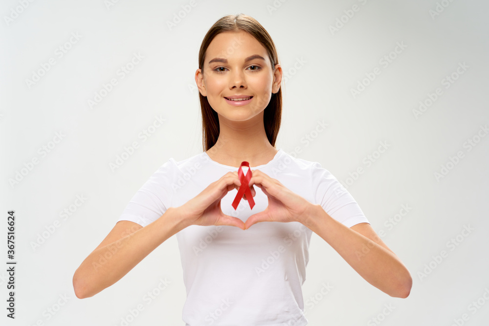 Health care charity girl holding a ribbon in her hand oncology support Health care charity girl holding a ribbon in her hand oncology support