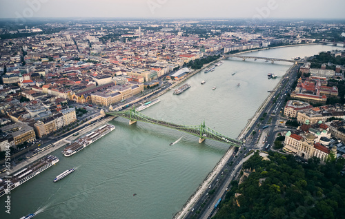 Aerial view of the Liberty Bridge by Danube river in Budapest, Hungary. Gathered people during summer evening. The Freedom Bridge is closed for motorised vehicles and open for pedestrians only.