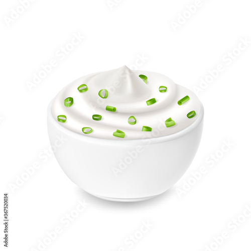 Sour cream sauce in white bowl, tartar, green onion and sour cream flavor, mayonnaise. Tasty food.