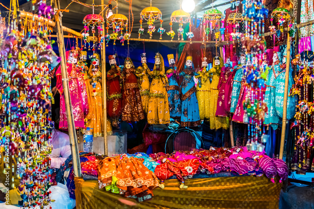 Colorful handmade Rajasthani puppet KATHPUTLI and colorful dresses in a doll shop in New Delhi, India