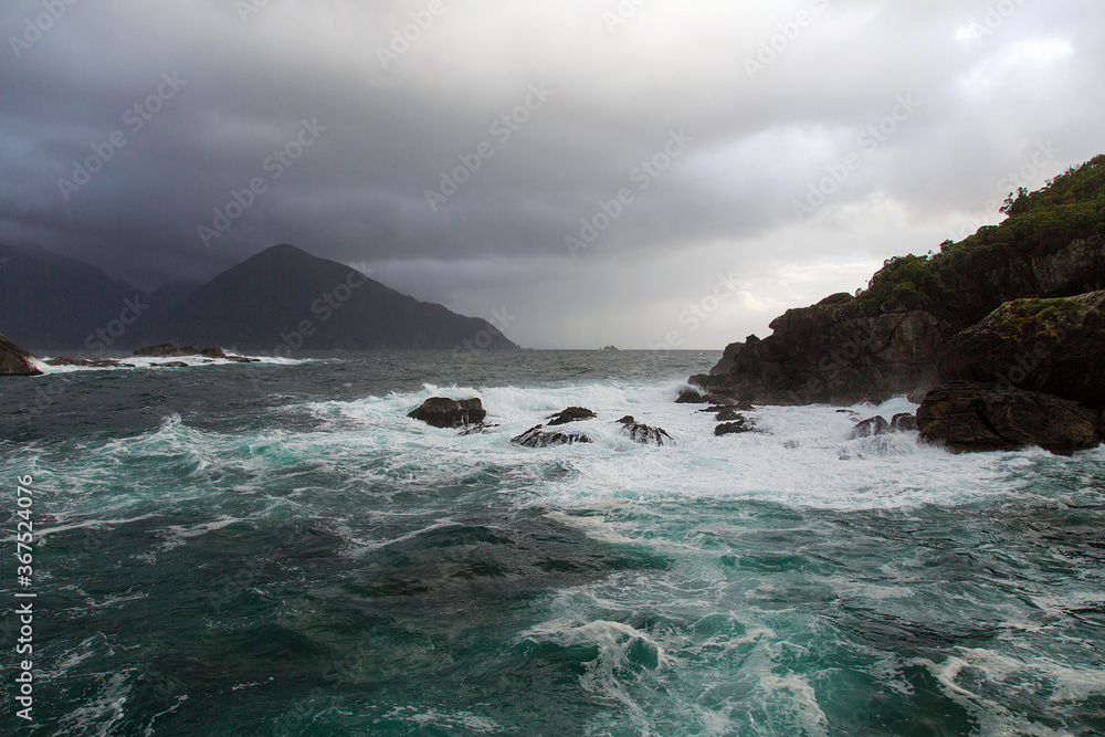 Crashing waves and rough seas in Doubtful Sound - Fiordland National Park at Tasman Sea. Crashing waves and rough seas in Doubtful Sound - Fiordland National Park at Tasman Sea.