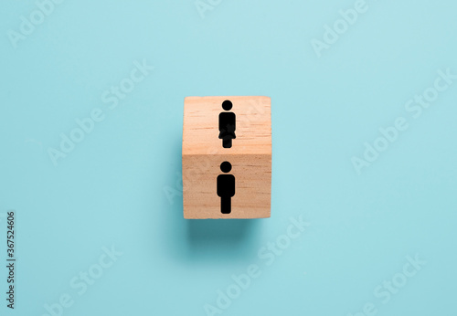 Opposite of man and woman icon on wooden block cube. Man and woman quite different thinking and behaviour. photo