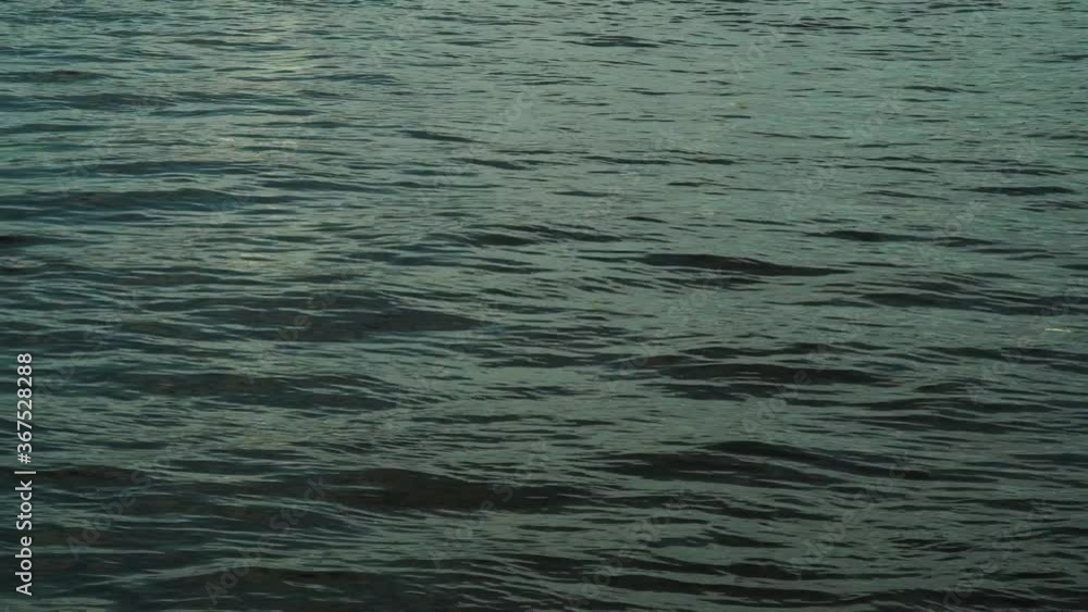 Light ripples on the surface of the river. Sun glare on the sea. Light ripples on the surface of the river. Sun glare on the sea.