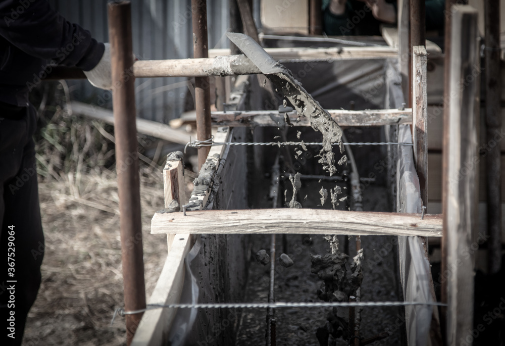 Fototapeta premium Pouring concrete into the foundation at a construction site.