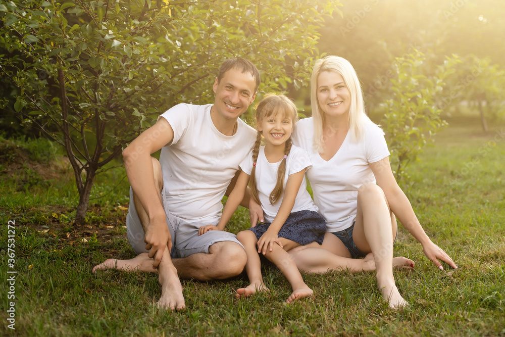 Fototapeta premium Portrait of cheerful extended family sitting in the park