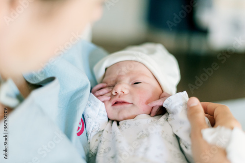 First moments of a newborn in mother's hands in a hospital