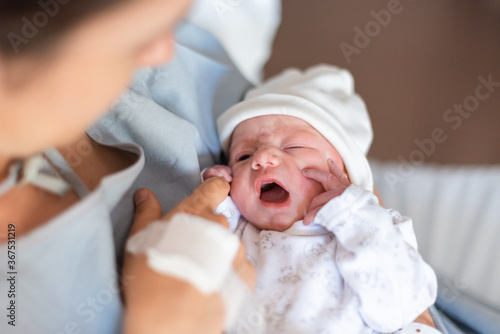 First moments of a newborn in mother's hands in a hospital