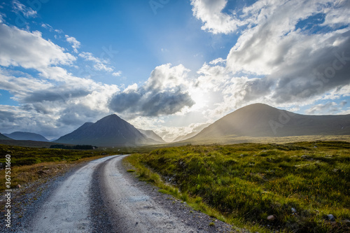 a lonely road heading towards the valley of glencoe in the argyll region of the highlands of scotland in summer photo