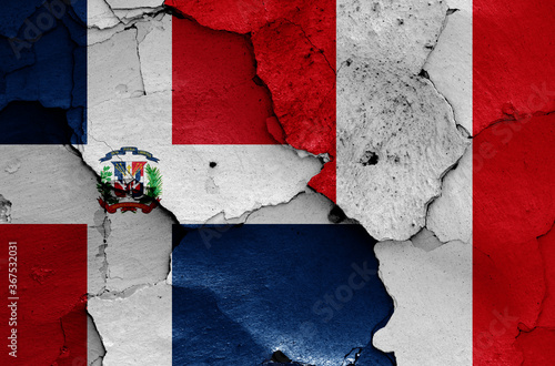 flags of Dominican Republic and Peru painted on cracked wall