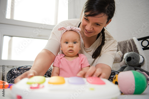 Wallpaper Mural The adorable baby looks at the camera while her mother watches over her Torontodigital.ca