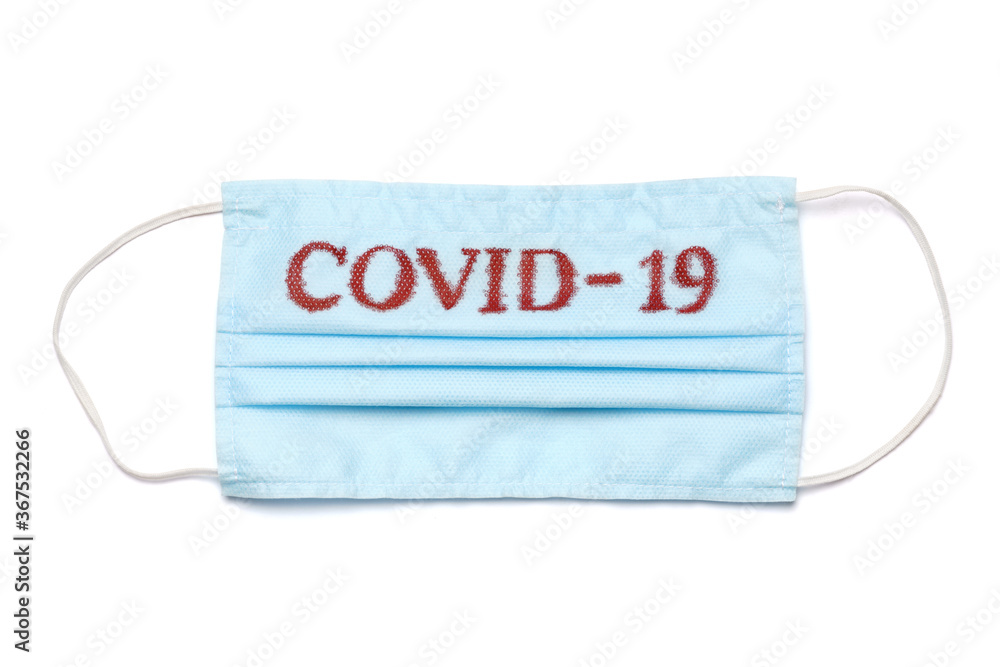 Disposable blue medical face mask with COVID-19 sign isolated on white background with clipping path Disposable blue medical face mask with COVID-19 sign isolated on white background with clipping path
