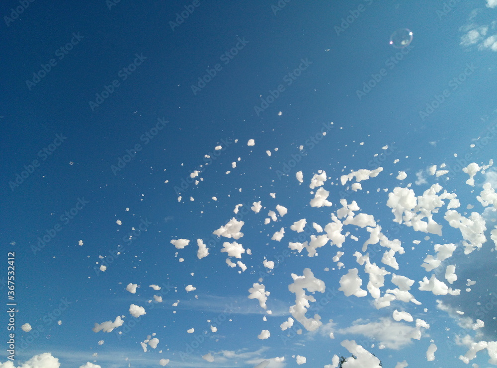 Lots of white foam against the blue sky Lots of white foam against the blue sky