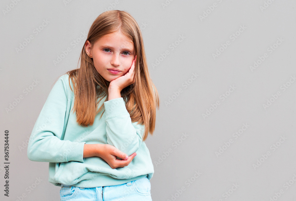 Portrait of young sad charming female student with blonde hair in stylish outfit holding head with hand, looking in camera with unhappy expression after receiving bad mark on exam Portrait of young sad charming female student with blonde hair in stylish outfit holding head with hand, looking in camera with unhappy expression after receiving bad mark on exam