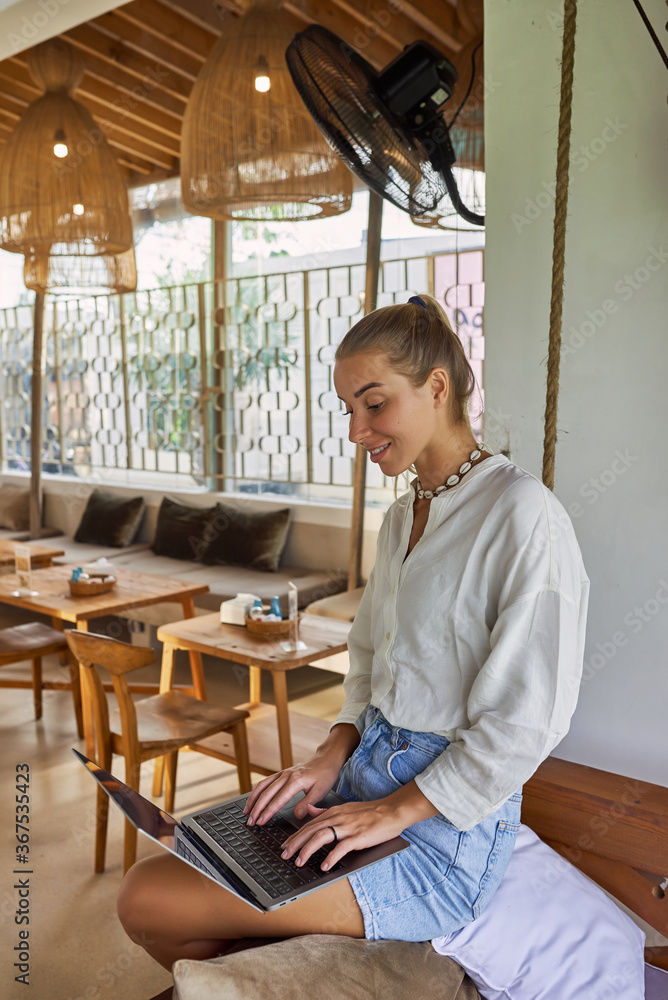 Girl blonde with a laptop sitting studying outdoors. Remote Quarantine. Girl blonde with a laptop sitting studying outdoors. Remote Quarantine.