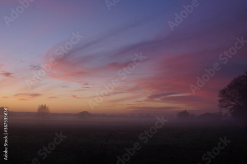 Misty Sunset orange light on swirling clouds Somerset atmospheric 
