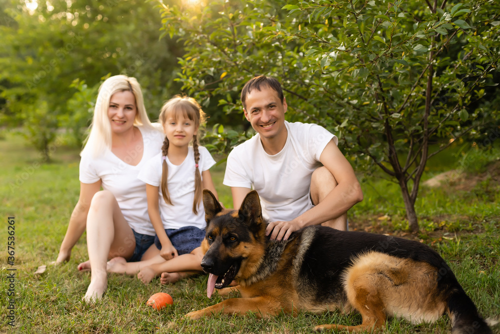 Portrait of cheerful extended family sitting in the park Portrait of cheerful extended family sitting in the park
