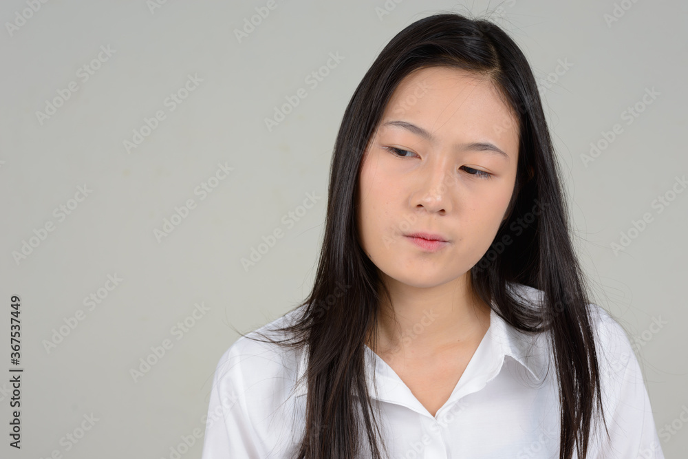 Portrait of young beautiful Asian businesswoman against white background Portrait of young beautiful Asian businesswoman against white background