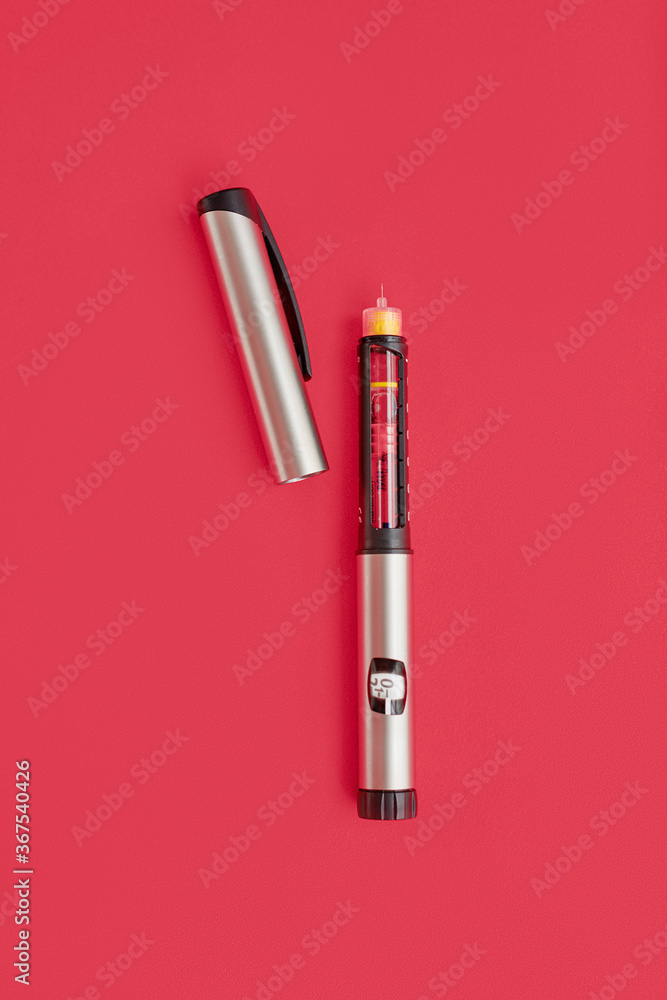 Insulin Pen on pink background, close-up, flat lay. Diabetes control concept Insulin Pen on pink background, close-up, flat lay. Diabetes control concept