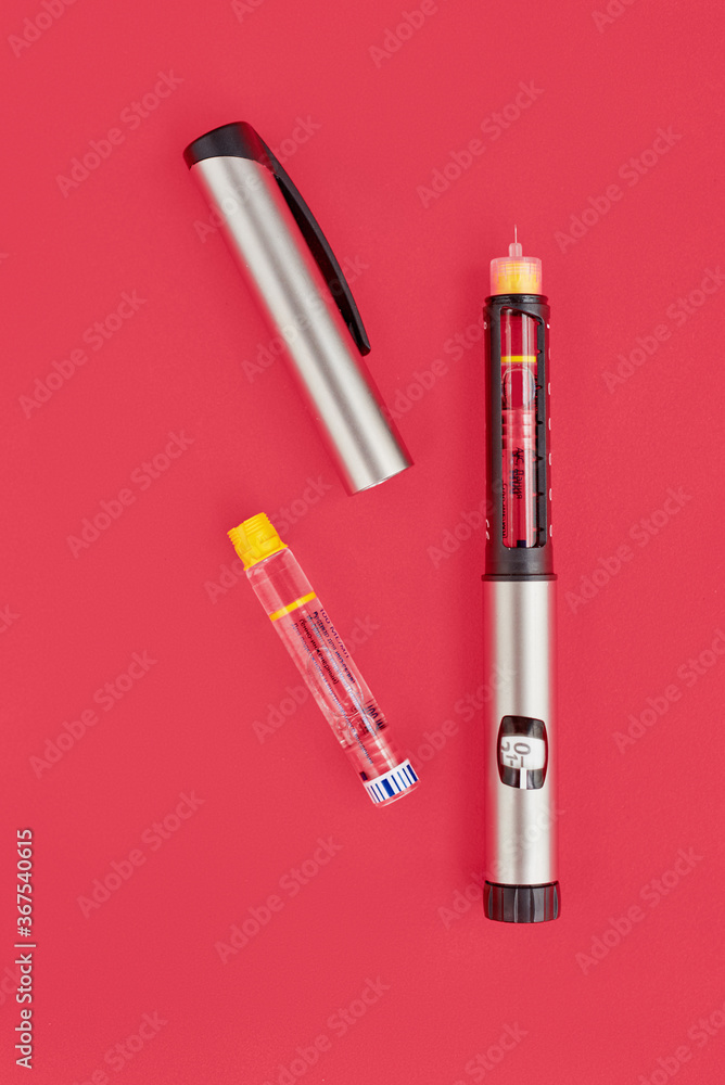 Insulin Pen on pink background, close-up, flat lay. Diabetes control concept Insulin Pen on pink background, close-up, flat lay. Diabetes control concept