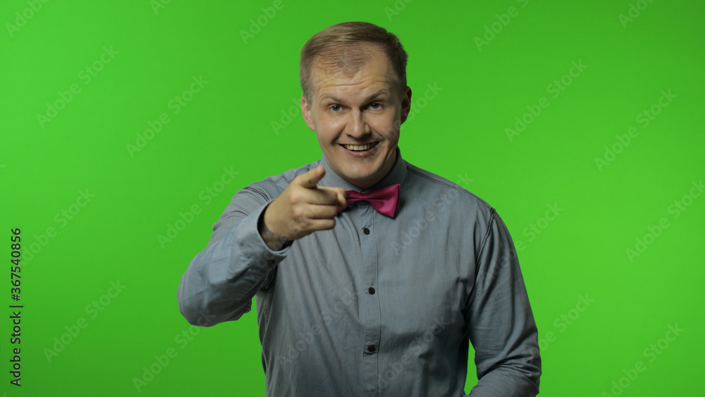 Happy man smiling to camera, laughing carefree and pointing finger to camera, choosing something Happy man smiling to camera, laughing carefree and pointing finger to camera, choosing something