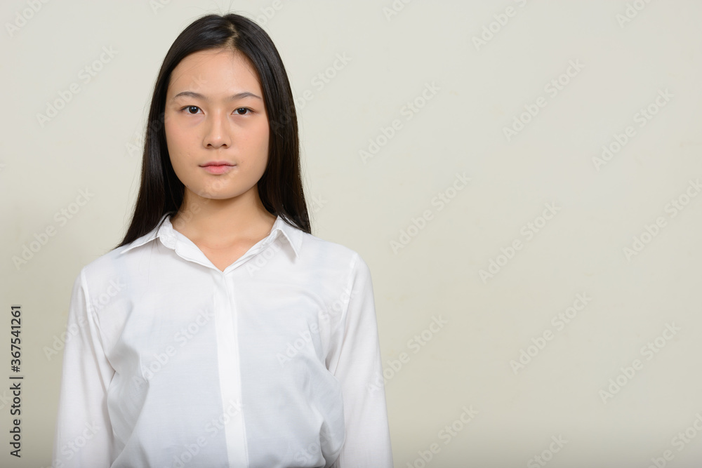 Portrait of young beautiful Asian businesswoman against white background Portrait of young beautiful Asian businesswoman against white background