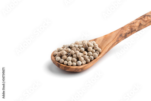 Isolated white pepper in the wooden spoon