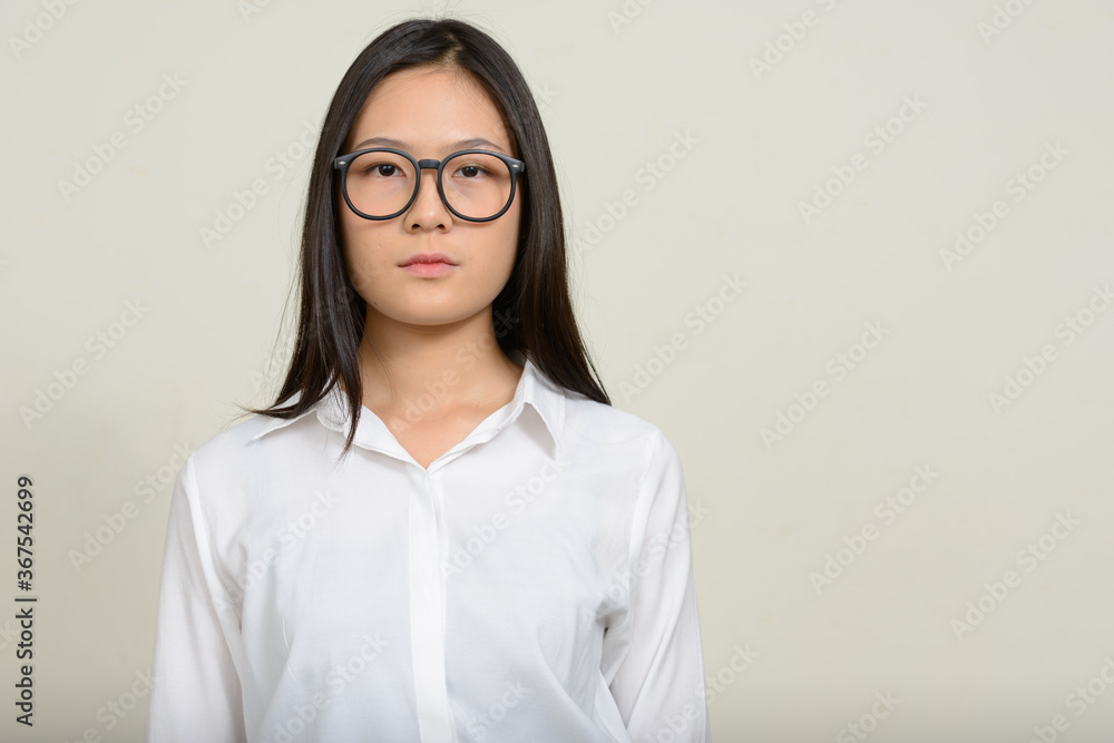 Portrait of young beautiful Asian businesswoman against white background Portrait of young beautiful Asian businesswoman against white background