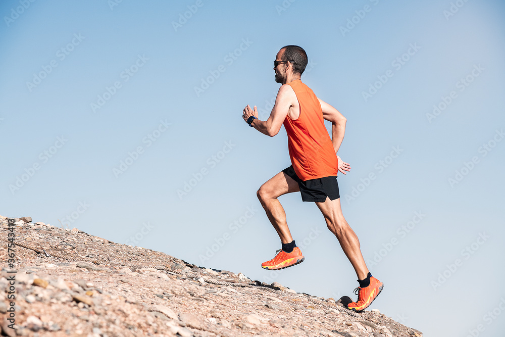 Athletic young man running in the nature. Healthy lifestyle