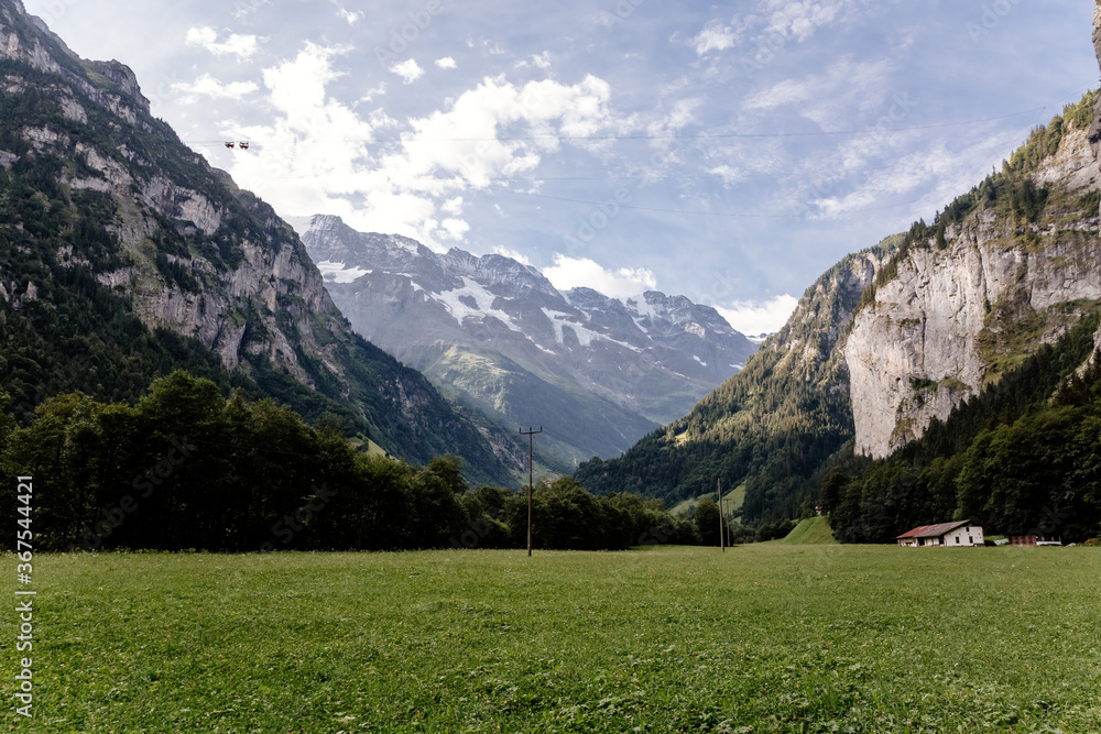 Scenic view on green mountings and sky in Lauterbrunnen Valley, Switzerland
