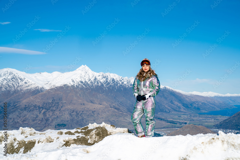 Beautiful asian woman enjoying and relaxing view with snow flake on snow mountain during winter in New Zealand.