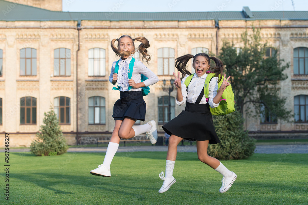 Fototapeta premium Excited school kids formal uniform running, hurry up concept