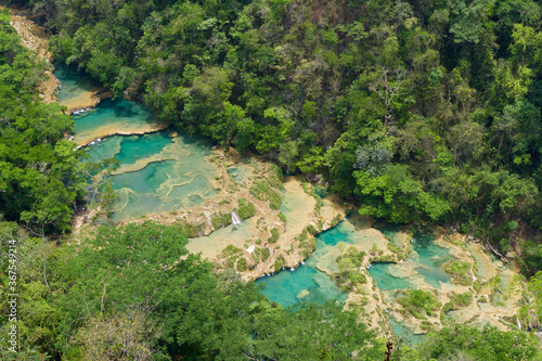 The emerald green river flows through the secluded Semuchanpay in Guatemala.