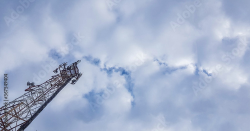 Mobile phone radio antenna tower. Cell tower against a cloudy sky