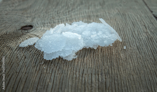 Flower of Greek sea salt crystals, south Crete. Natural traditional Fleur de sel from Crete. Sea salt flakes on wooden bakcground.