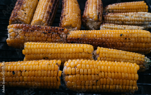 Corn fried on the fire. Hot sweet corn grill. An ear of corn. Healthy food for vegans.