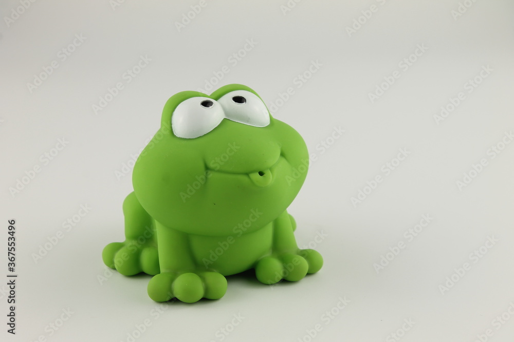 Fototapeta premium green rubber bath toy frog side facing with big eyes, isolated on a white background