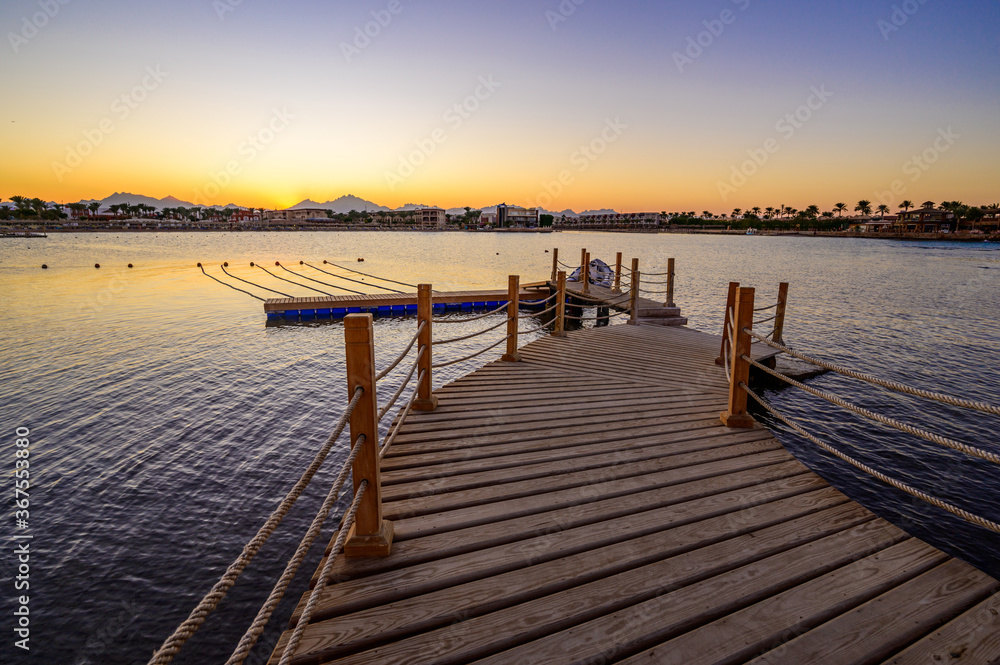 Wooden Pier on Red Sea in Hurghada at sunset, Egypt - travel destination in Africa Wooden Pier on Red Sea in Hurghada at sunset, Egypt - travel destination in Africa