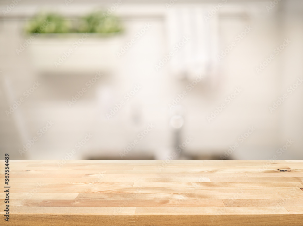 Wood table top on blur kitchen counter (room)background Wood table top on blur kitchen counter (room)background