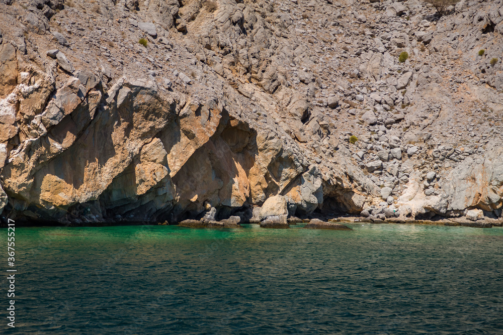 Coastal Khasab Scenery in Oman. Beautiful coastal scenery near Khasab, in Musandam peninsula, Oman, photo taken from a boat during a tour.
