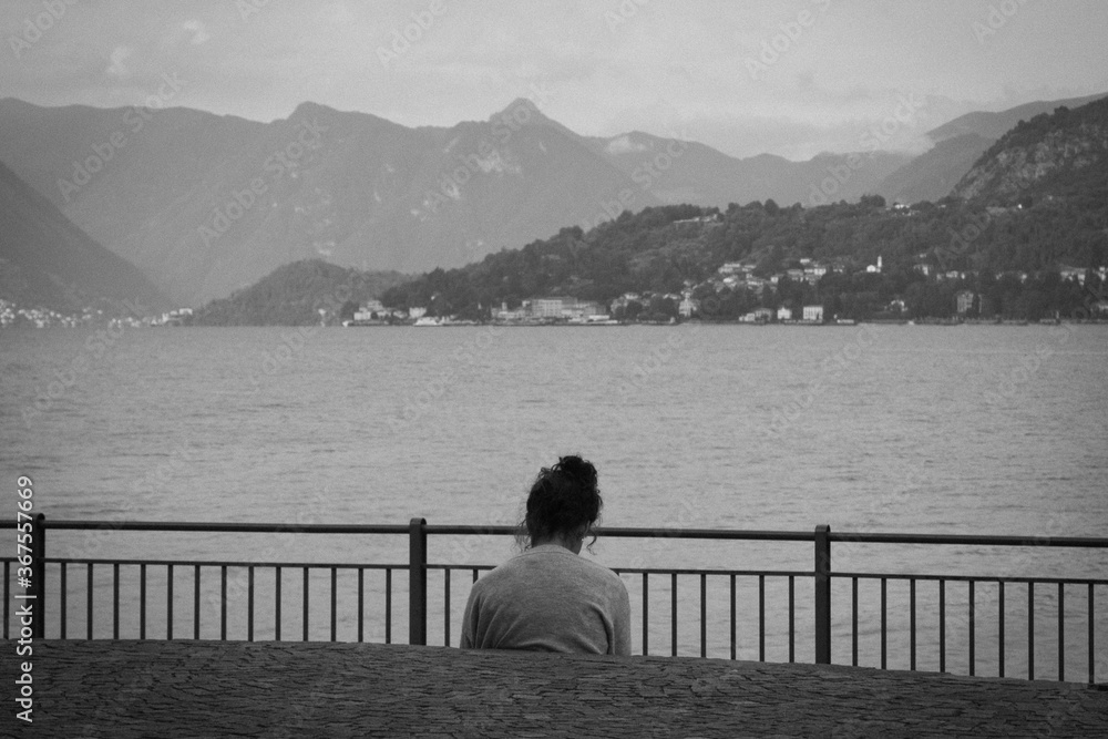Admires the lake.
Black and white photo with lady in relax that admire the landscape lake.