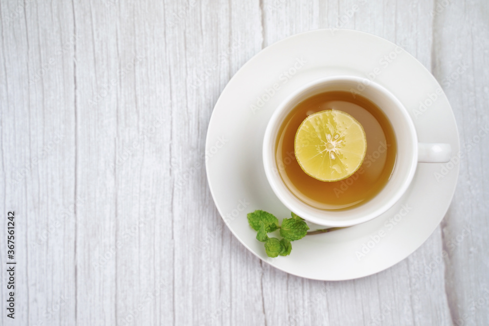 Top view of Cup of hot honey lemon tea and mint on wooden table. the concept of natural medicine. Top view of Cup of hot honey lemon tea and mint on wooden table. the concept of natural medicine.