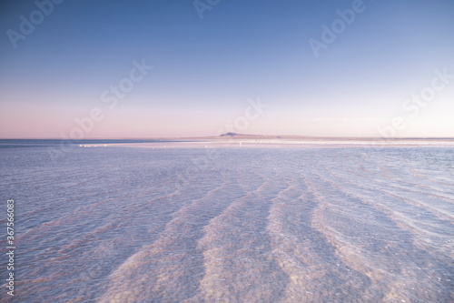 Nature beautiful sunset on the lake. Salt lake in the Astrakhan region. Clear water. Pink sunset landscape.