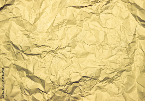Crumpled gold background. Wrinkled gold texture.