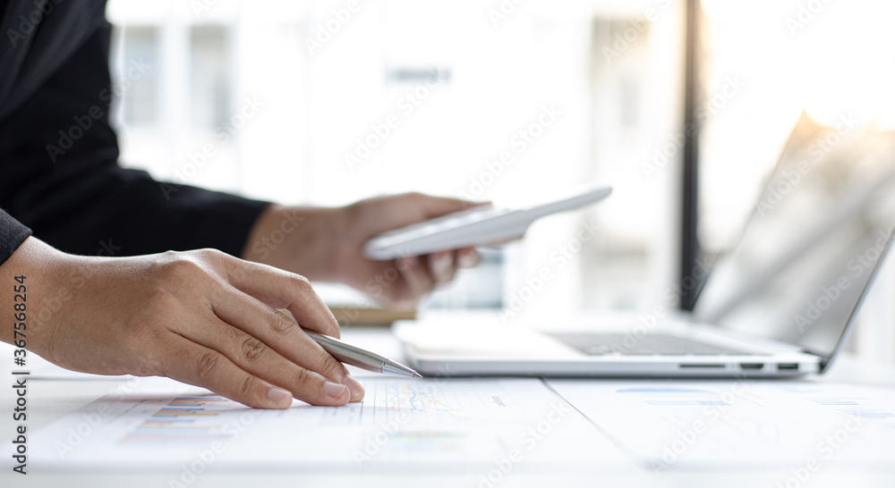 Asian woman is working on finances on her desk. Asian woman is working on finances on her desk.