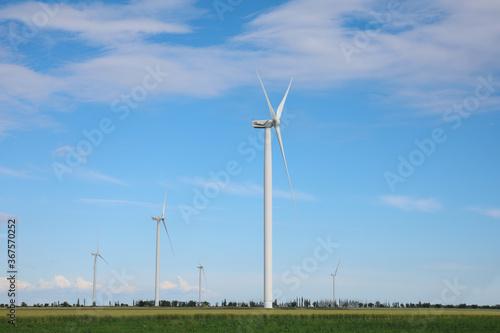 Beautiful view of field with wind turbines. Alternative energy source