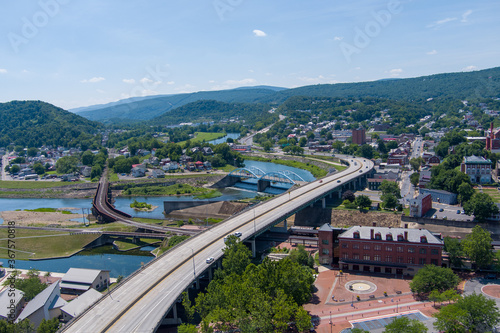 Interstate 68 passes through Cumberland, Allegany County, Maryland. A railroad bridge on the left crosses the Potomac River to Ridgeley, West Virginia. photo