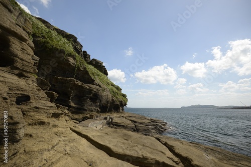 Beautiful shot of rock formations near the water on a summer day in Jeju Island, South Korea